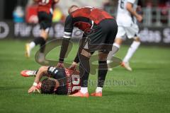 3. Liga - Saison 2026/27 - FC Ingolstadt 04 - SV Wehen Wiesbaden - Linus Rosenlöcher (Nr.19 - FCI) verletzt am Boden - Lars Lokotsch (Nr.13 - FCI) - Foto: Meyer Jürgen