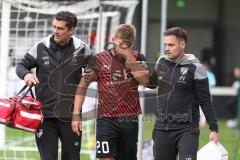 3.Liga - Saison 2023/2024 - SC Verl - FC Ingolstadt 04 - Yannick Deichmann (Nr.20 - FCI)verletzt am Boden und muss ausgewechselt werden - Betreuer auf dem Spielfeld - - Foto: Meyer Jürgen