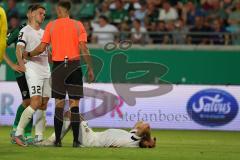 3.Liga - Saison 2023/2024 - Preußen Münster - FC Ingolstadt 04 - Yannick Deichmann (Nr.20 - FCI) verletzt am Boden - Simon  Lorenz (Nr.32 - FCI) -  - Foto: Meyer Jürgen